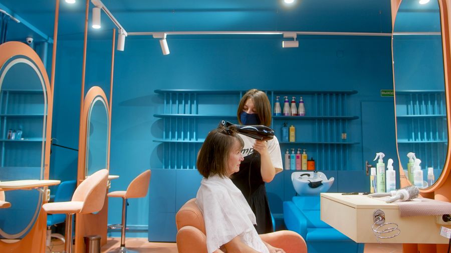 Hairdresser styling a client's hair